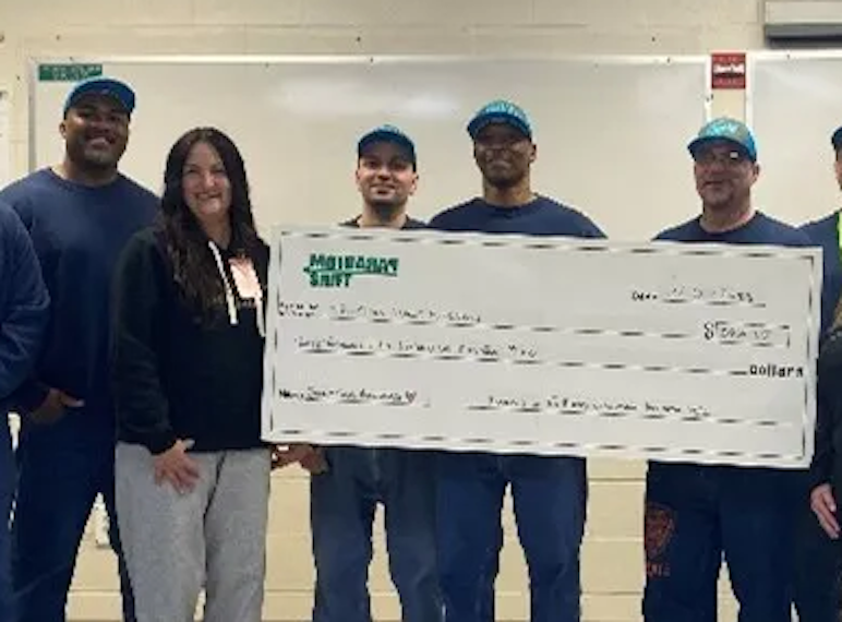 Two members of the Tri-Cities Cancer Center visited the Paradigm Shift Club at Two Rivers Correctional Institution to receive their long-awaited check from the Breast Cancer awareness fundraisers