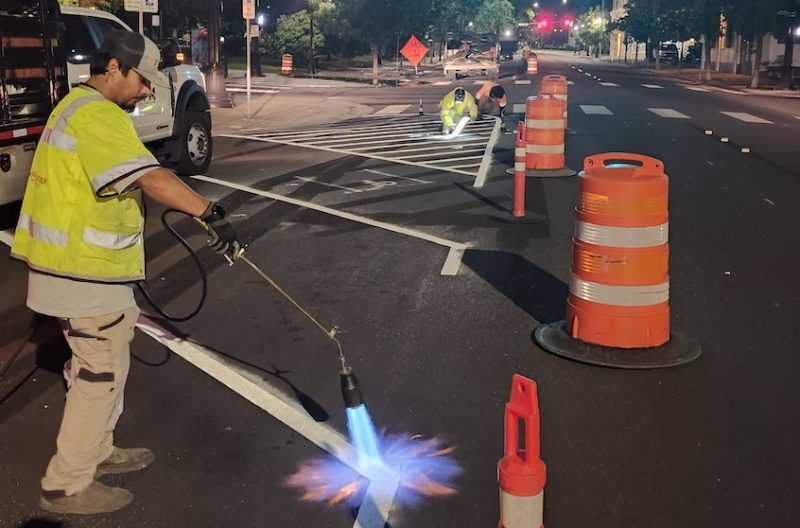 Medford crews install new pavement markings and parking layout on Main Street as work continues overnight
